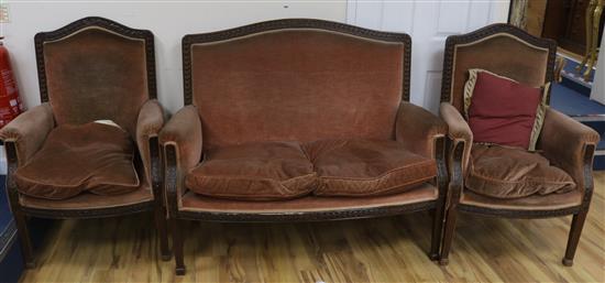 A carved walnut framed three piece suite, sofa W.135cm